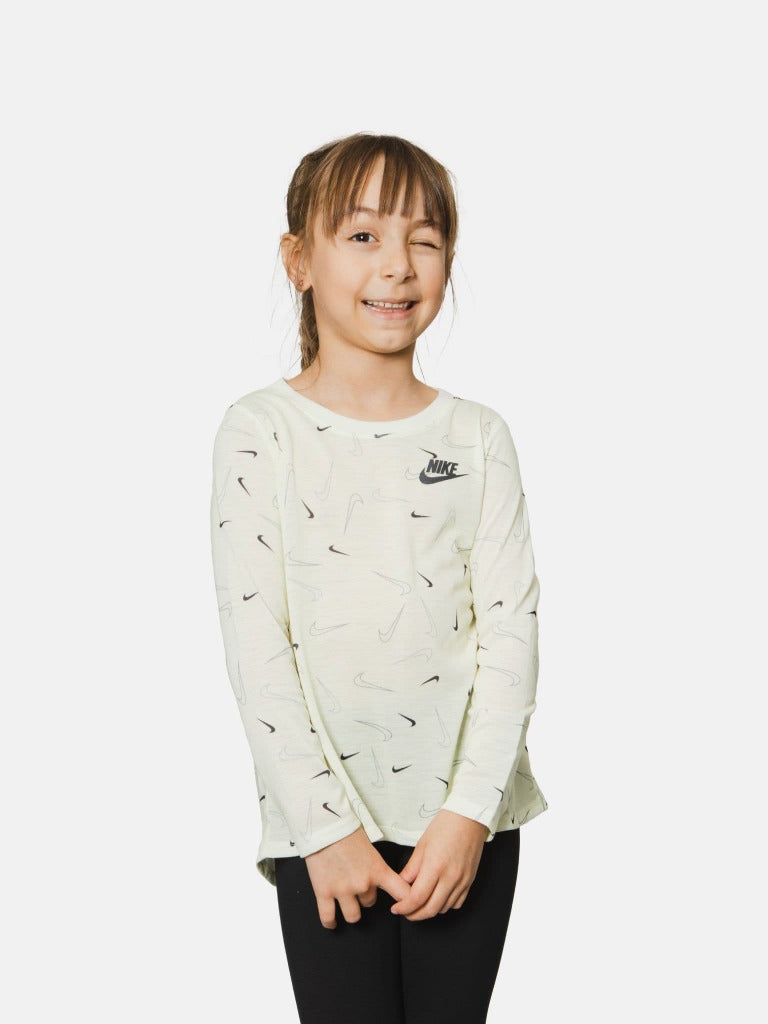 Indulge in the ultimate comfort and adorable style of the Nike Swooshfetti  set. Crafted with the utmost care, this set offers a perfect balance of  softness and flowiness. The long-length tunic top